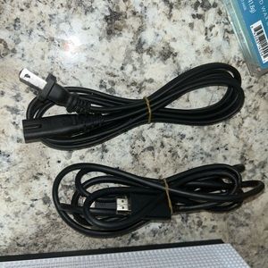 It comes with a HDMI cord, power cord, and one black controller with a design